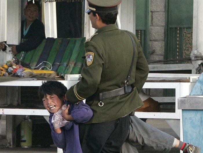 Tibetan child taken away by police