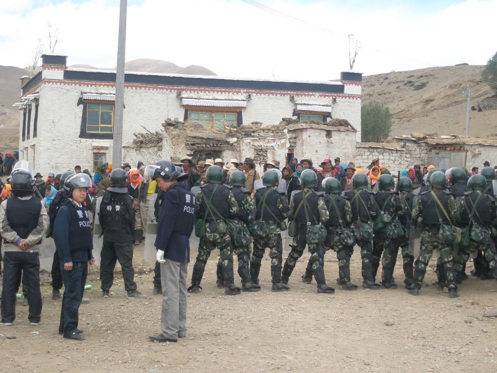 Tibetans protest against China’s mining in Shigatse, 2011, whilst Chinese police look on.