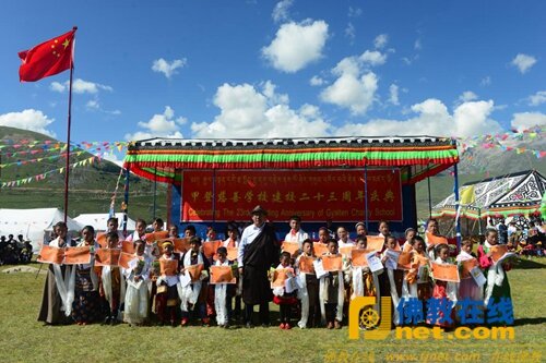 Gyalten Lobsang Jampa with students holding school certificate on the school’s 23rd founding anniversary