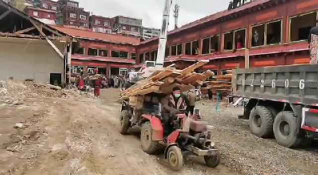 In photographs from the demolition, Tibetans can be seen removing building materials by hand, alongside others using machinery