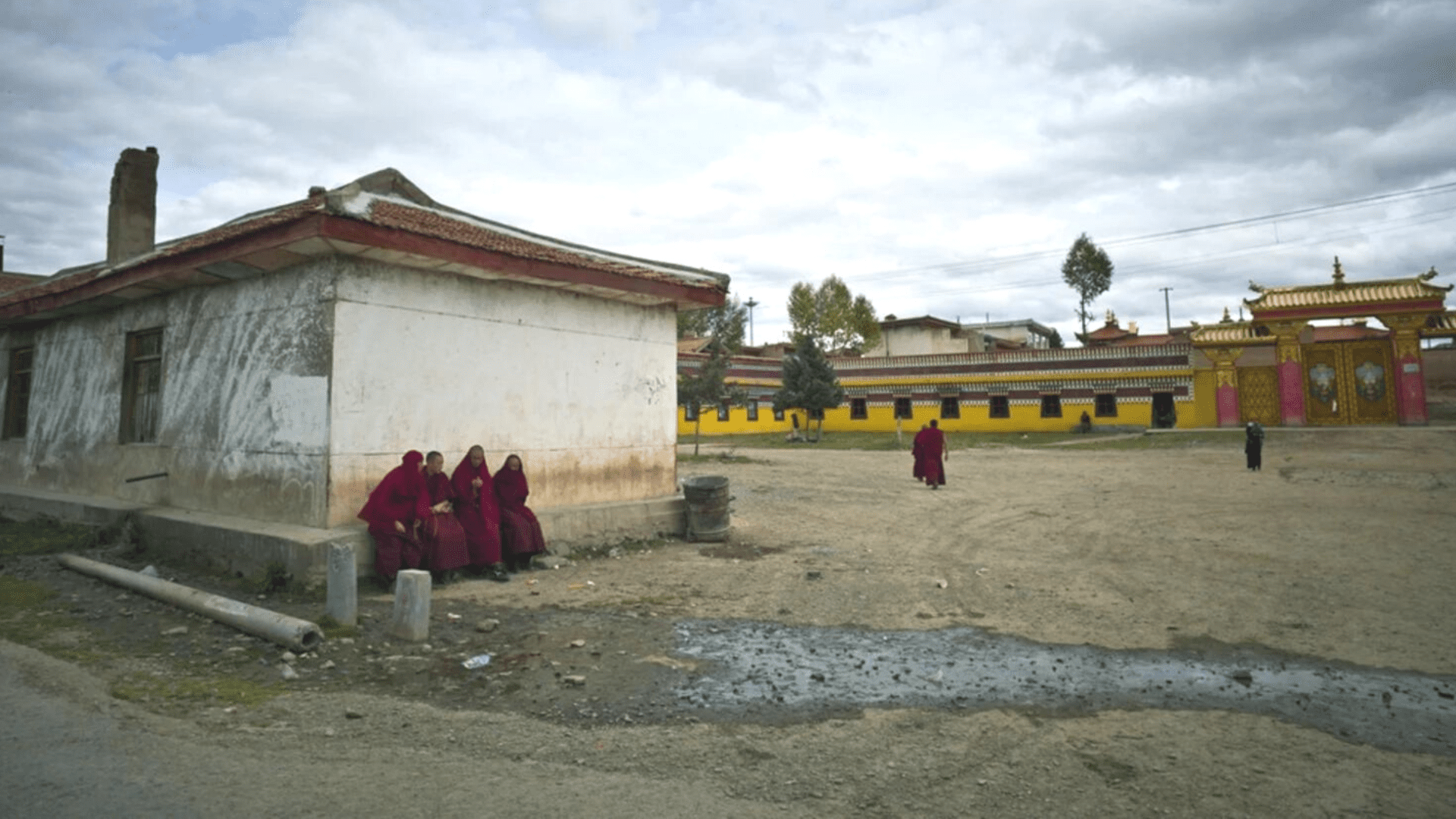 Monks sit near the entrance of Kirti monastery in Ngaba, 2011