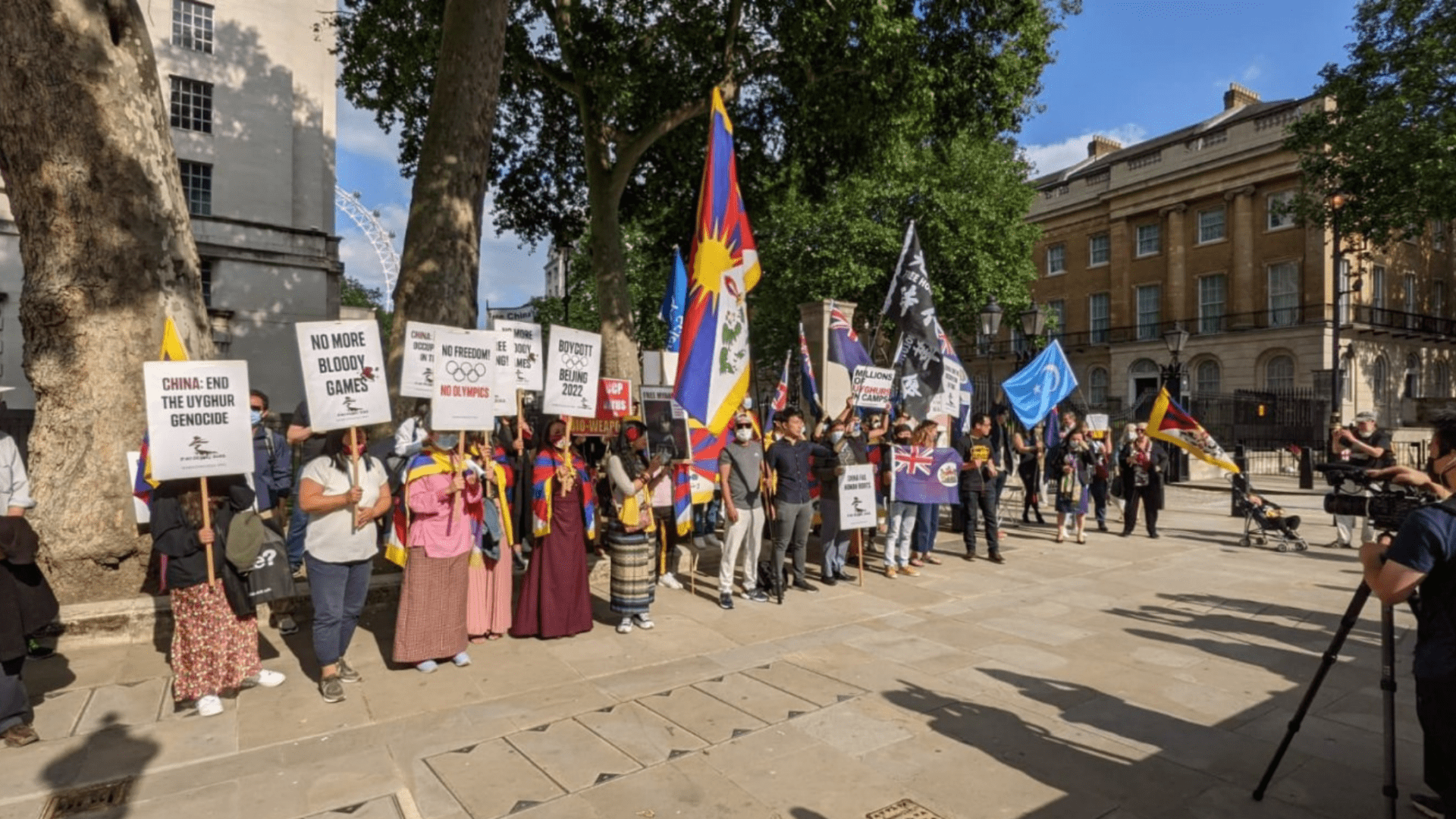 Protesters stand opposite Downing Street calling for a boycott of Beijing 2022