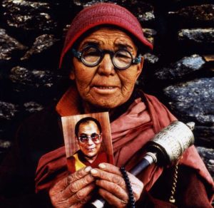 Tibetan woman holding Dalai Lama image