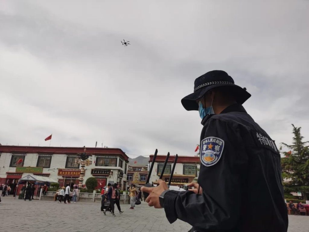 Police operating a drone in the sky above Lhasa