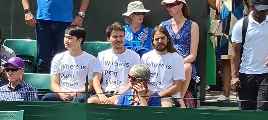 Three of the activists seated in the stands at Wimbledon later that afternoon