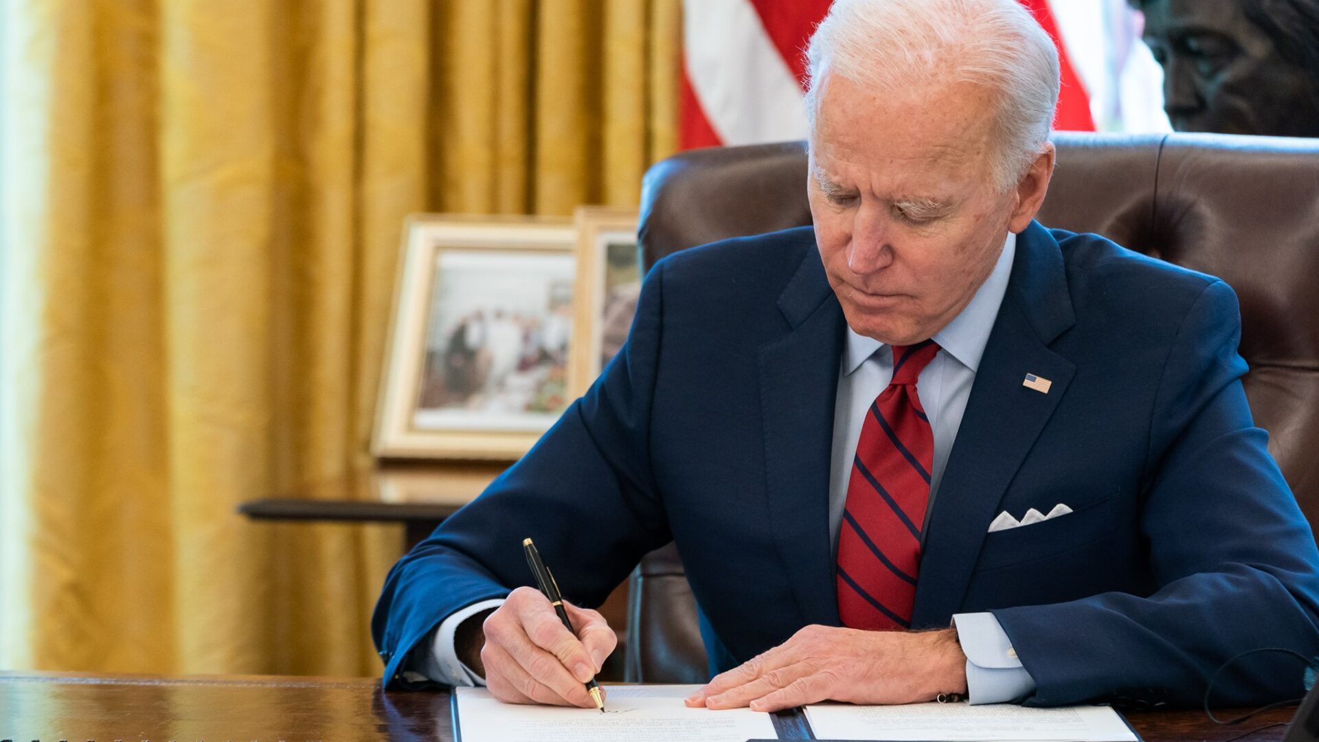 President Joe Biden signs a bill into law.